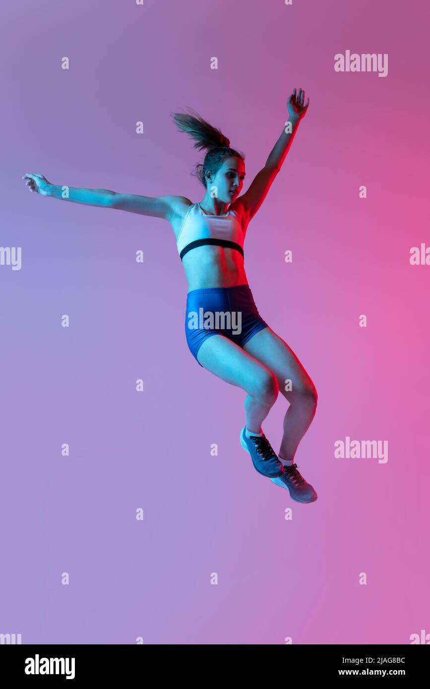 Training in long jump sport. Young girl, female athlete practicing