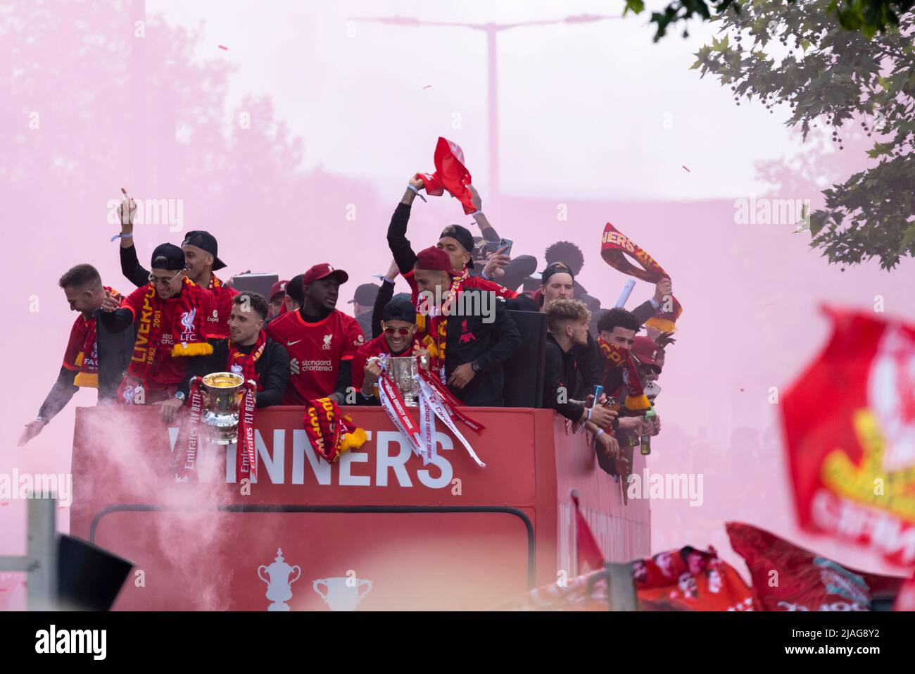 Liverpool Football Club victory parade through the streets of the city celebrating the League Cup and FA Cup trophy wins. Players on open top bus Stock Photo