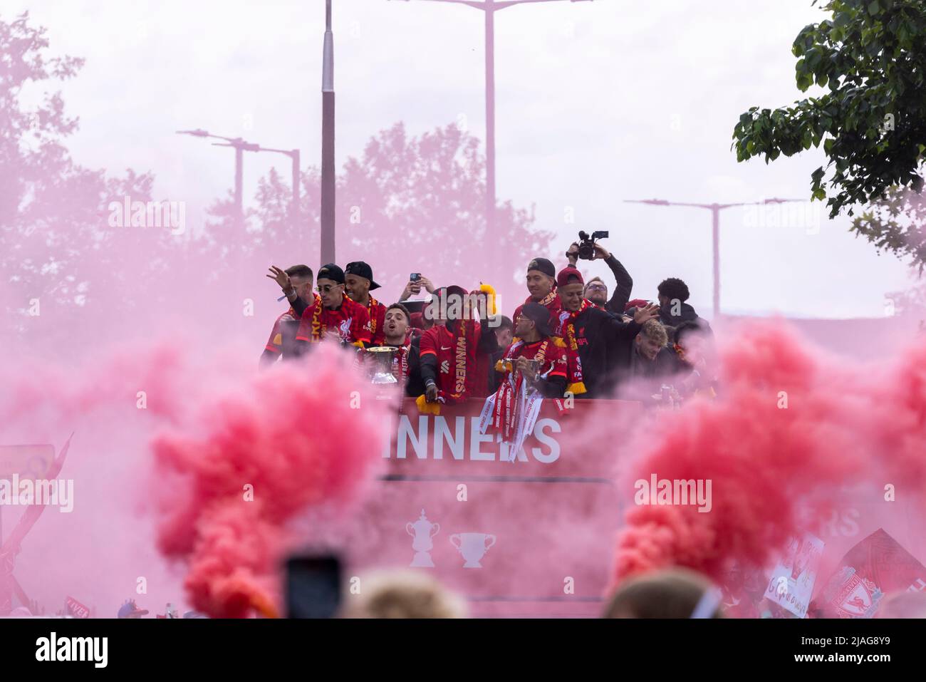 Liverpool Football Club victory parade through the streets of the city celebrating the League Cup and FA Cup trophy wins. Players on open top bus Stock Photo