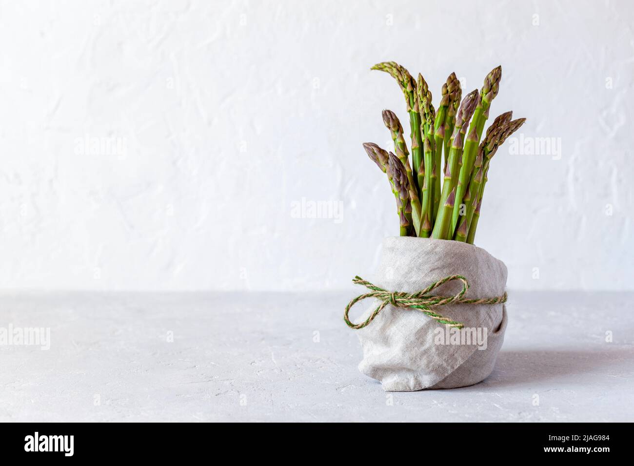 Bundle of asparagus in a pot on the grey background Stock Photo Alamy