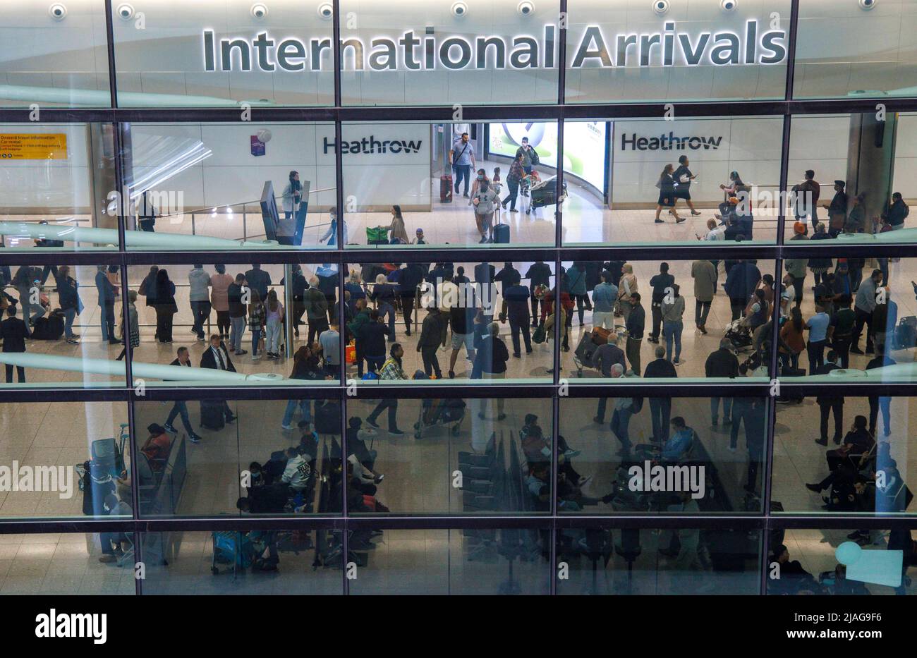 London, UK. 30th May, 2022. A busy arrivals lounge at Terminal 2 as the airport is under severe pressure with cancelled flights and staff shortages. Hundreds of passengers in long queues at Heathrow Terminal 2. Thousands of passengers have had their flights cancelled at short notice as travel chaos returns to the UK just as the Half term break begins. British Airways has cancelled 140 short haul flights from London Heathrow on Monday May 30th. Credit: Mark Thomas/Alamy Live News Stock Photo