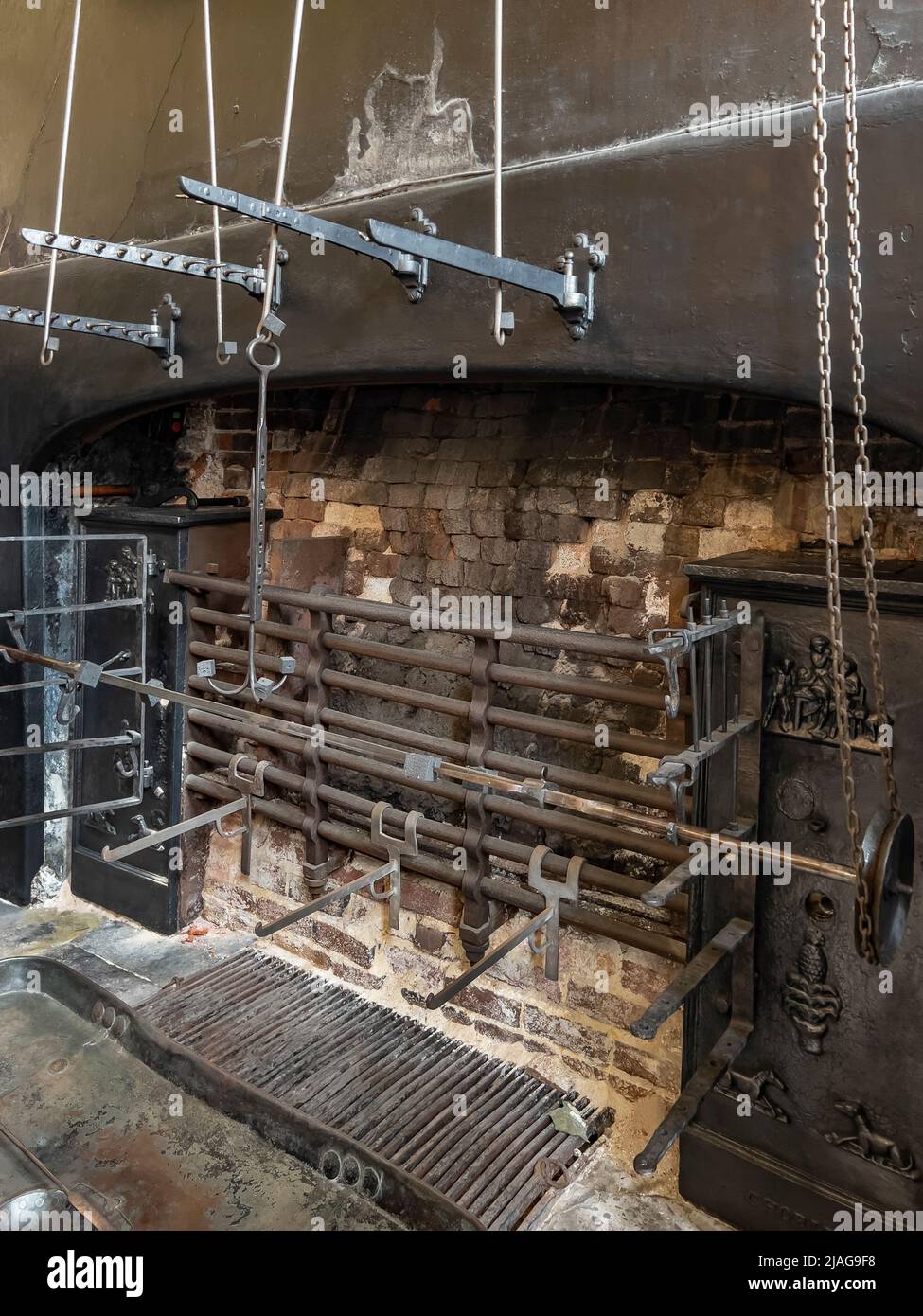 The spit roast in the 18th Century Kitchen at Petworth House in West Sussex, United Kingdom.  Petworth is a late 17th-century Grade I listed country h Stock Photo