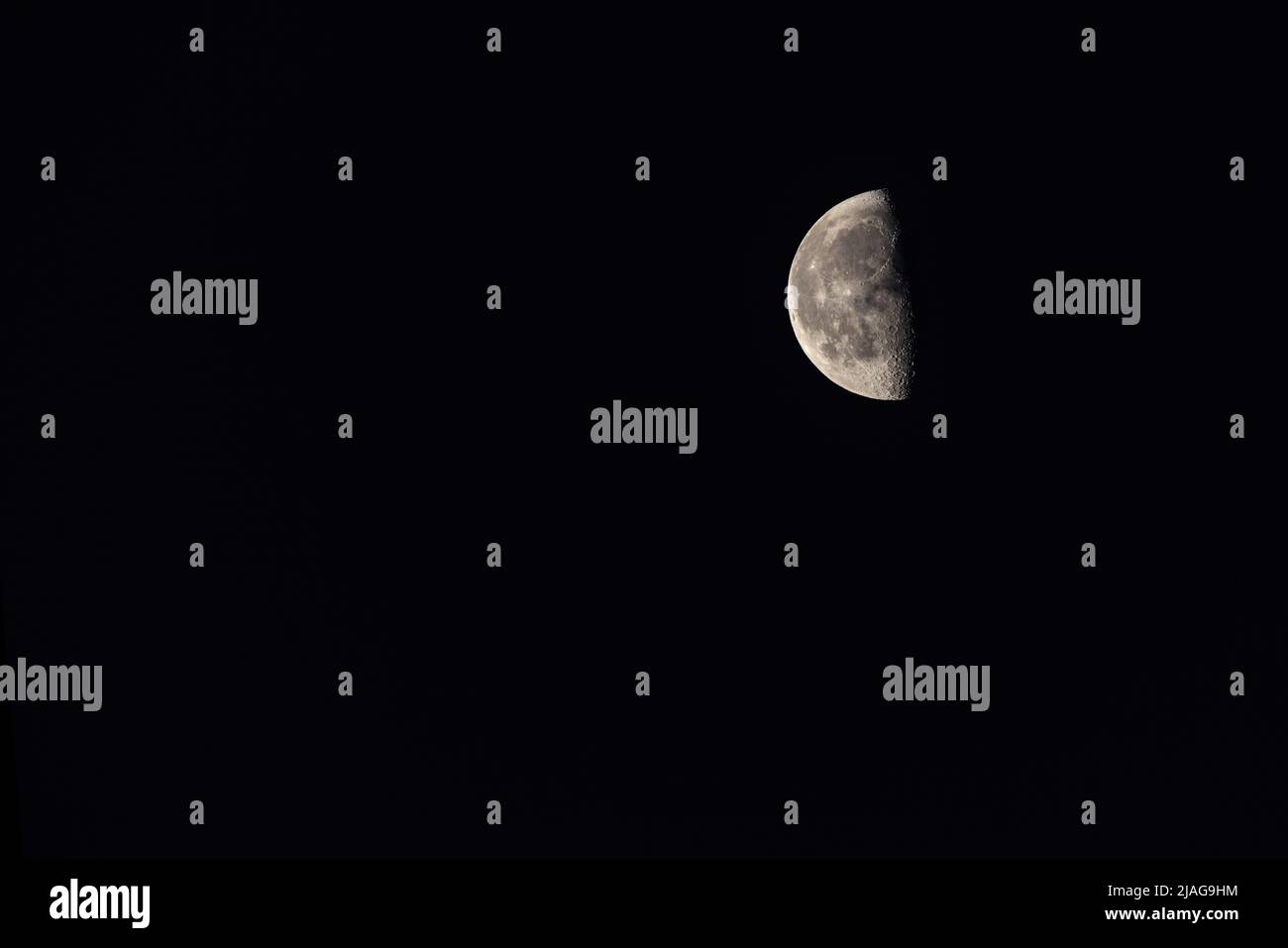 Crescent moon on dark night sky Stock Photo