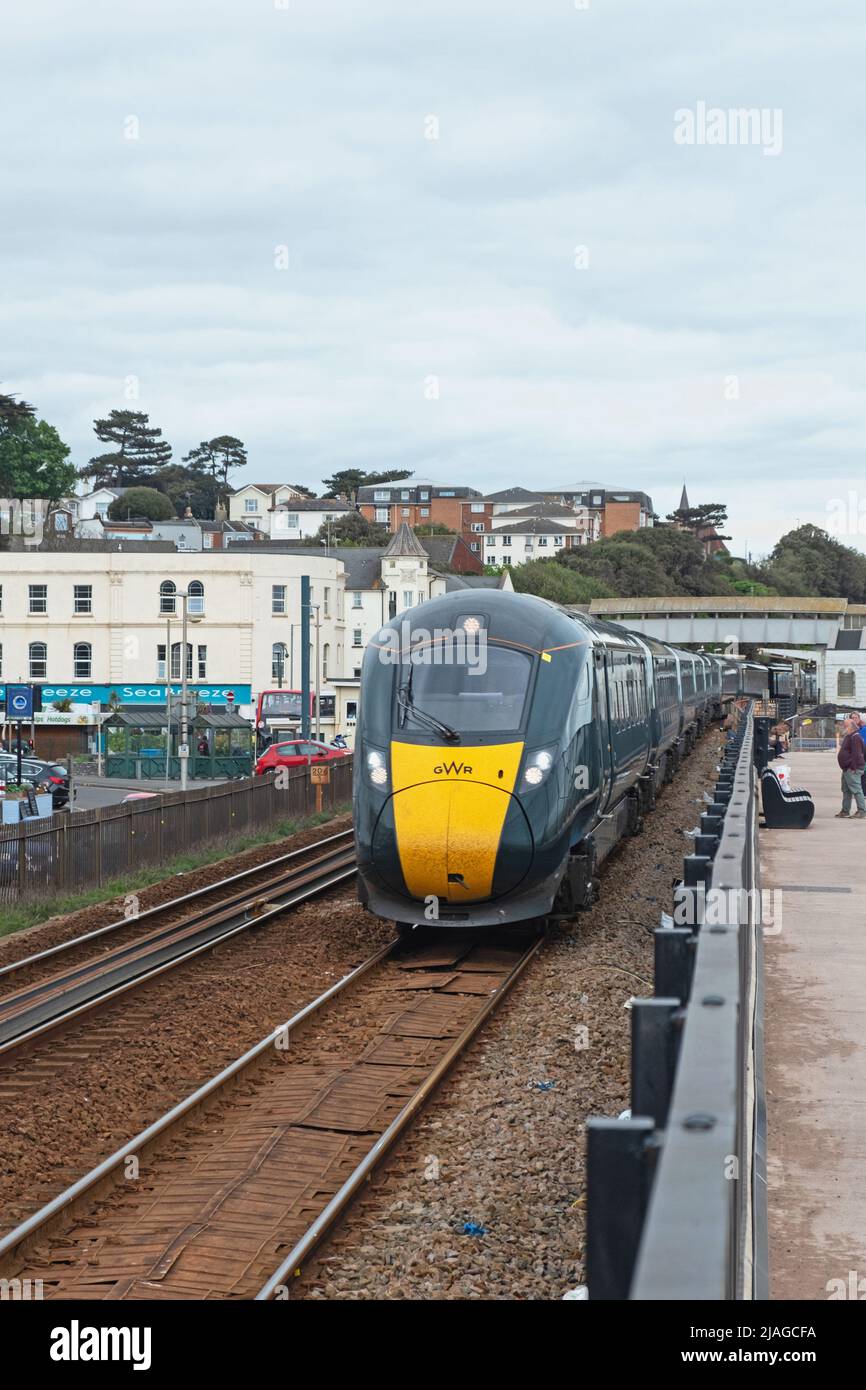 Dawlish, England - May 12, 2022: An Great Western Railway inter city passenger train departing the town’s station Stock Photo