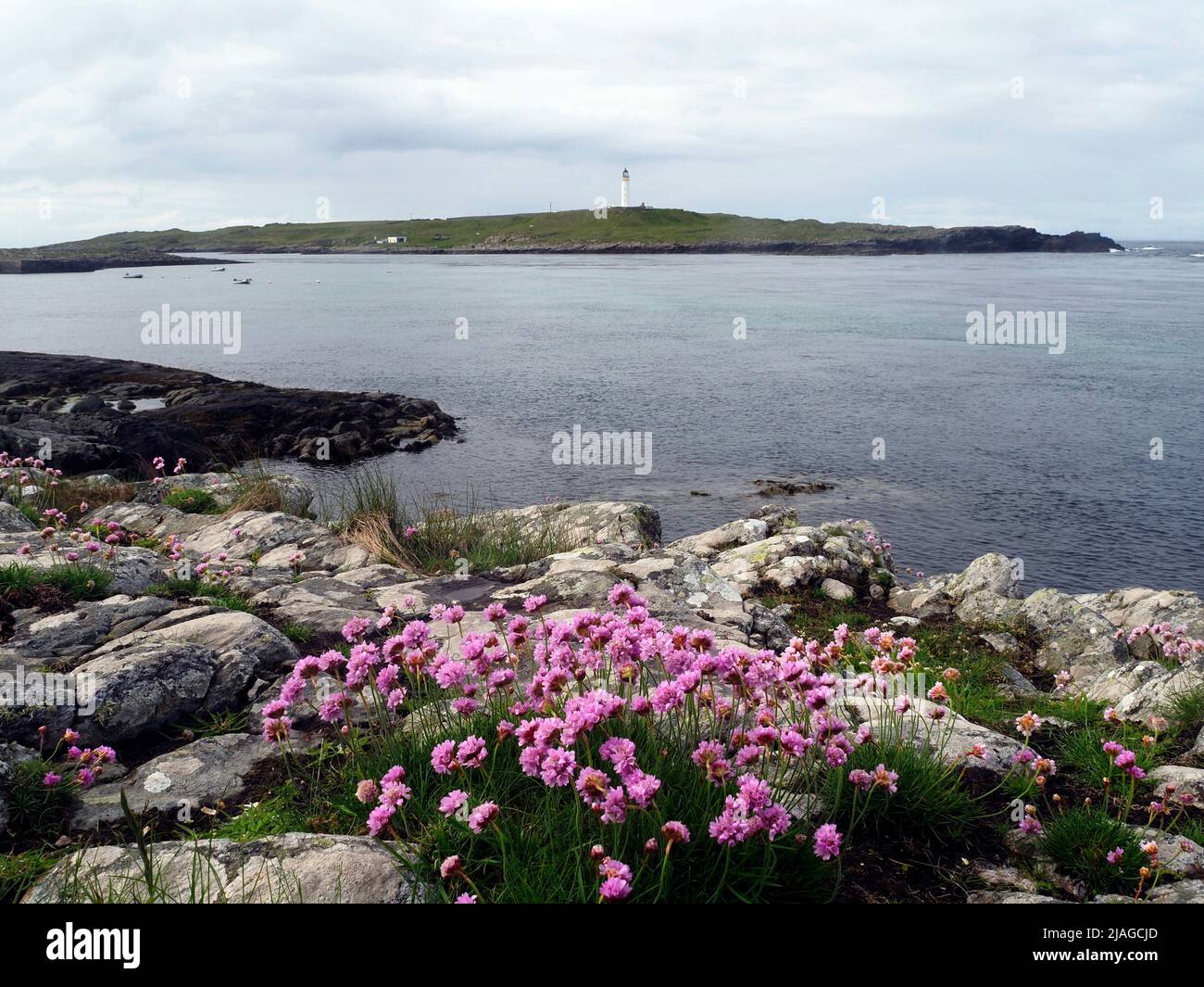 Orsay island and lighthouse from Portnahaven, Rinns of Islay Stock Photo
