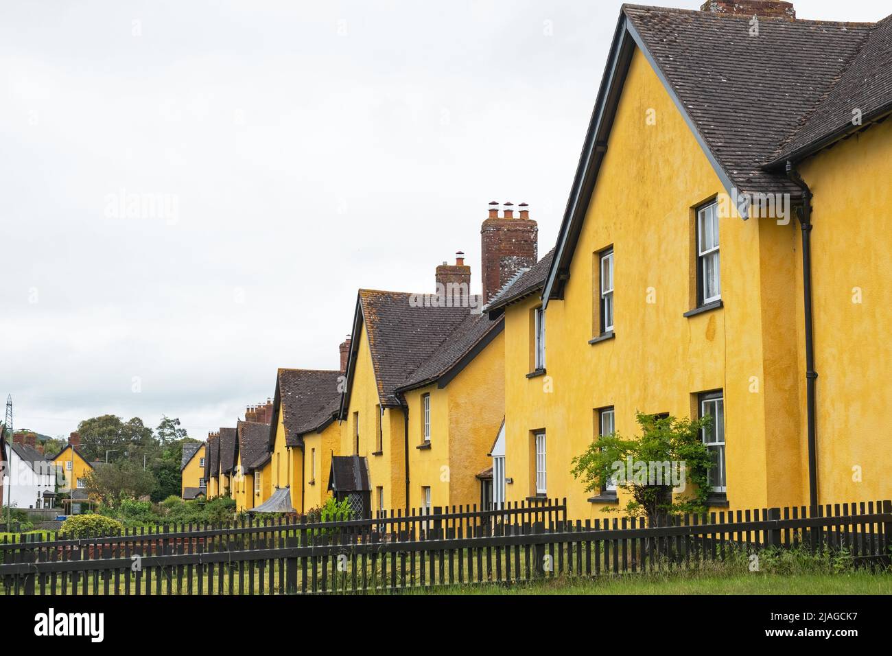 Row of distinctively painted cottages in an East Devon village, UK Stock Photo