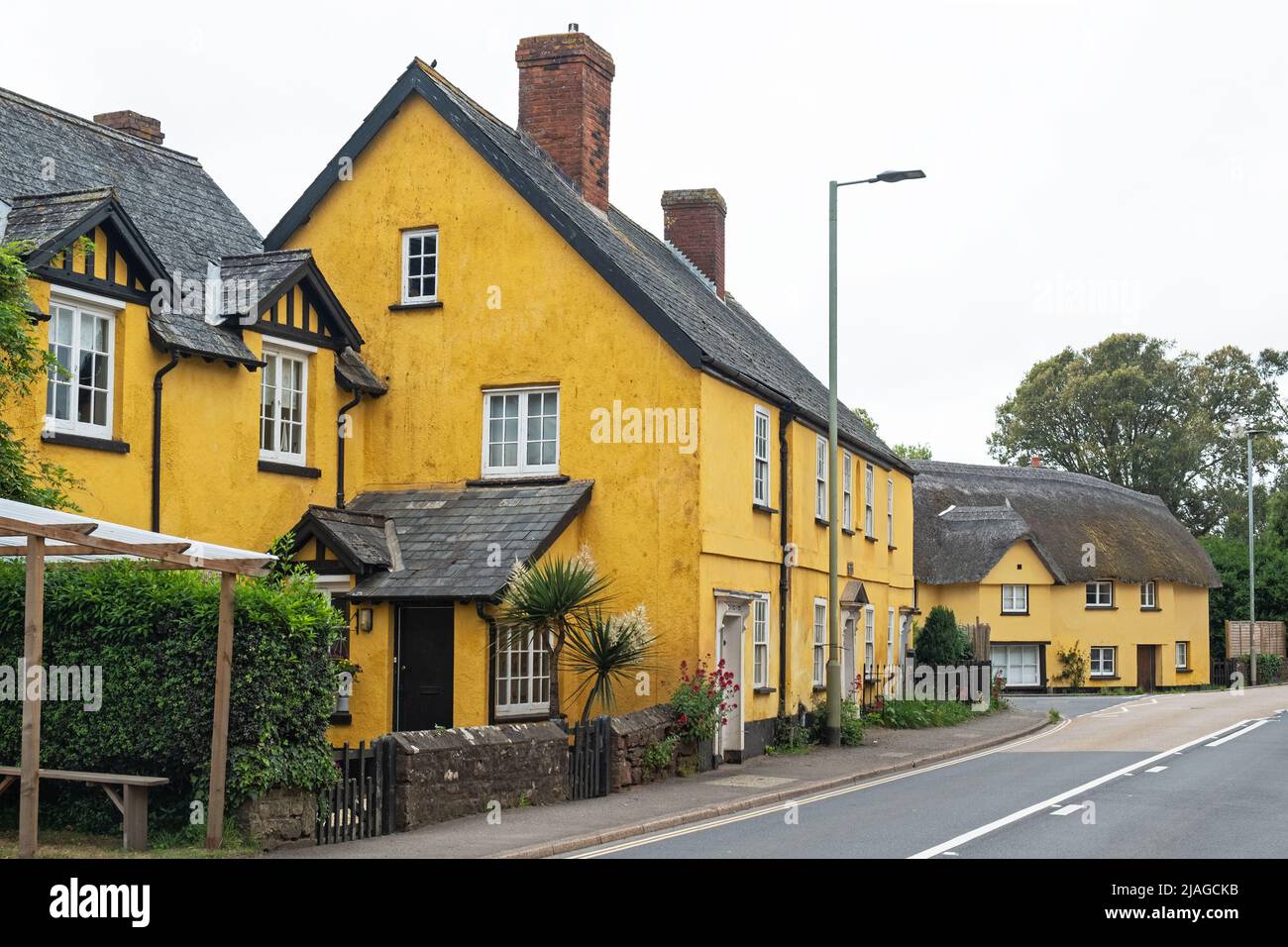 Distinctively painted houses at a village crossroads in East Devon, UK Stock Photo