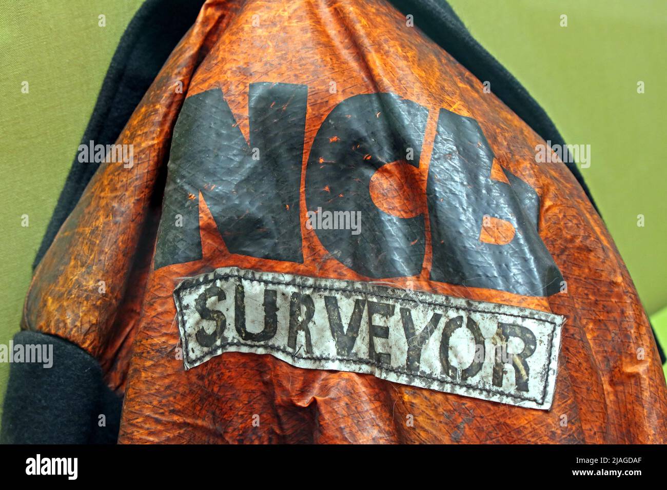 NCB national Coal Board Surveyor orange jacket, hanging up at head of a coil mine, colliery, South Wales, UK Stock Photo