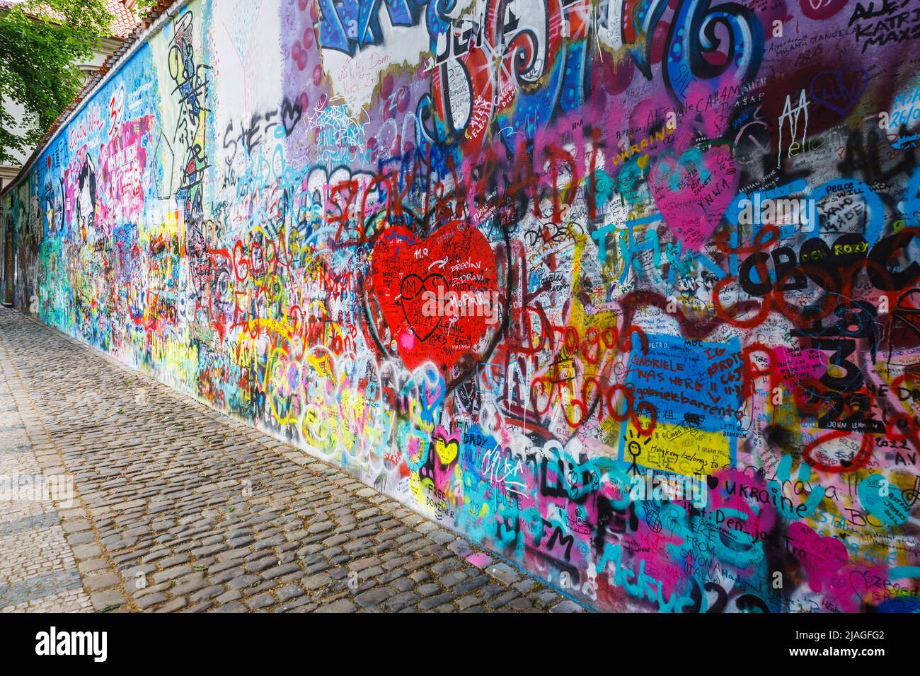 Lennon Wall Graffiti covered wall inspired by Lennon in the Prague
