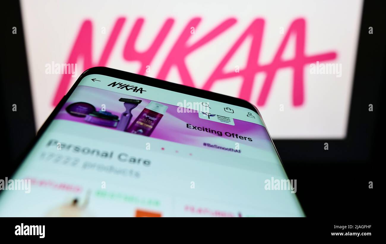 Smartphone with website of e-commerce company Nykaa E-Retail Pvt. Ltd. on screen in front of business logo. Focus on top-left of phone display. Stock Photo