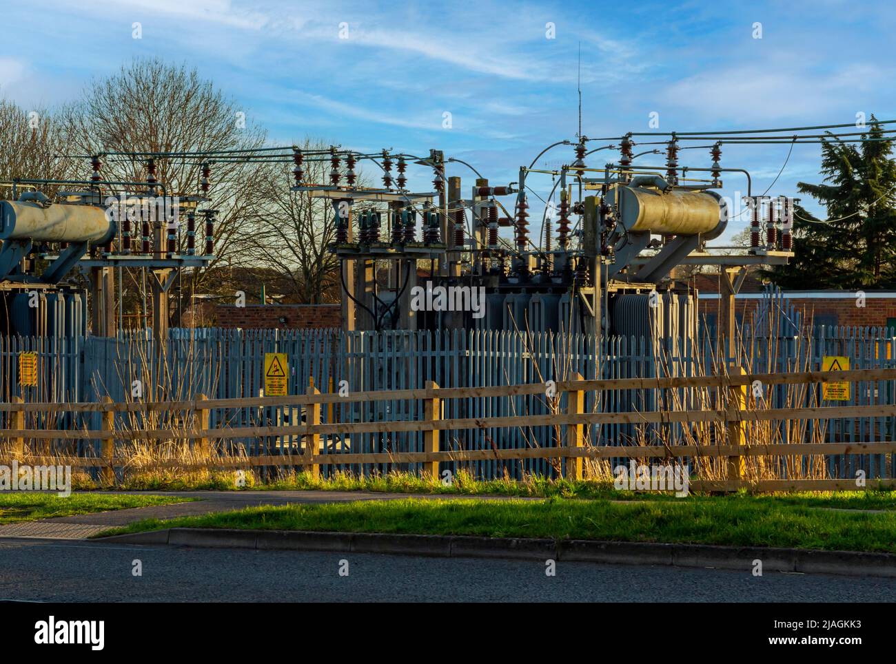 Electrical substation with metal and wooden fencing in foreground in Tewkesbury Gloucestershire England UK. Stock Photo