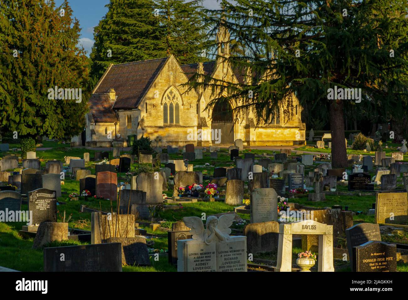 View over tombstones towards the Chapel building in Tewkesbury Cemetery Gloucestershire England UK which opened in 1857. Stock Photo
