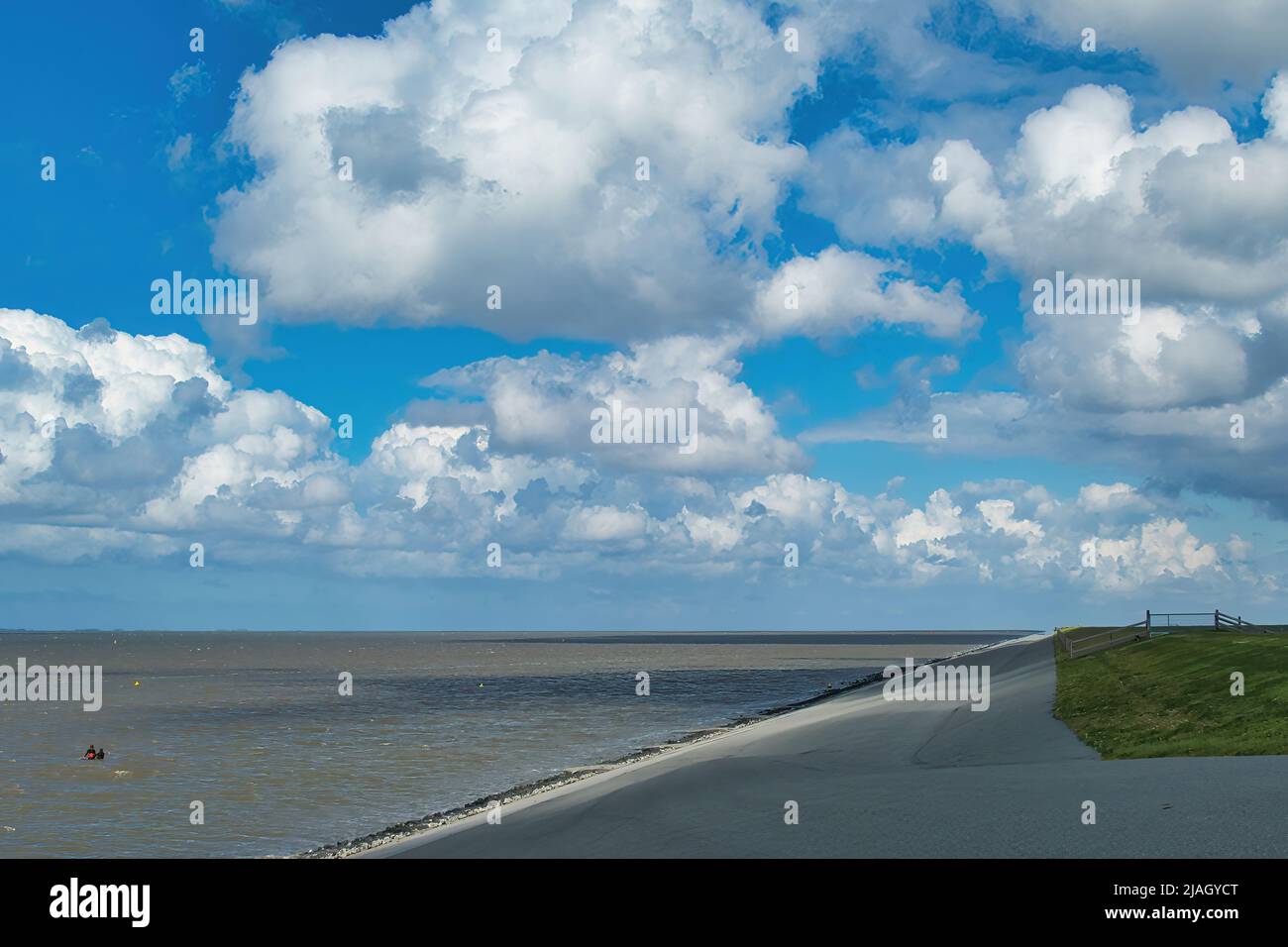 The sea dyke near Lauwersoog on the Wadden Sea, province of Groningen, in the north of the Netherlands. Cloudscape. Stock Photo