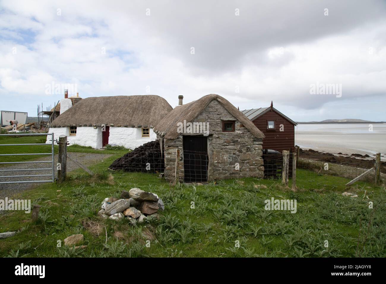 Traditional 19th century crofters stone cottages with thatched roofs near Sollas on North Uist, Outer Hebrides, Scotland. Stock Photo