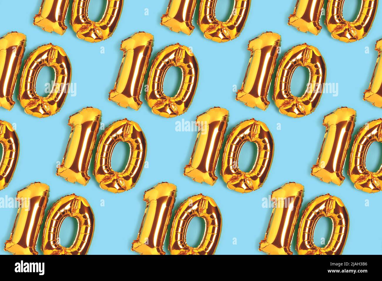 Number 10 golden balloons pattern. Ten years anniversary celebration concept on a blue background. Stock Photo