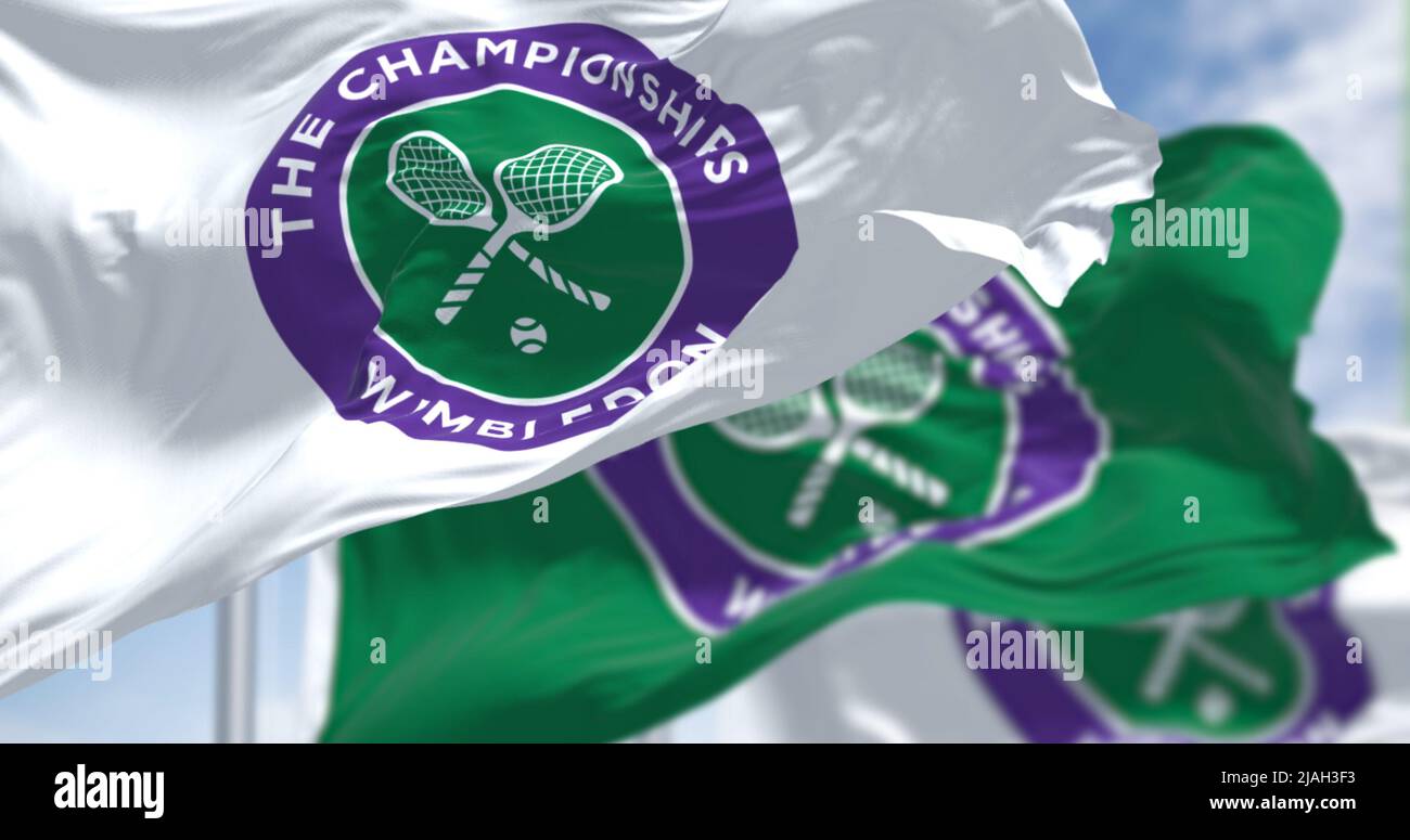 London, UK, April 2022: three flags with the The Championships Wimbledon logo waving in the wind. Wimbledon Championships is a major tennis tournament Stock Photo