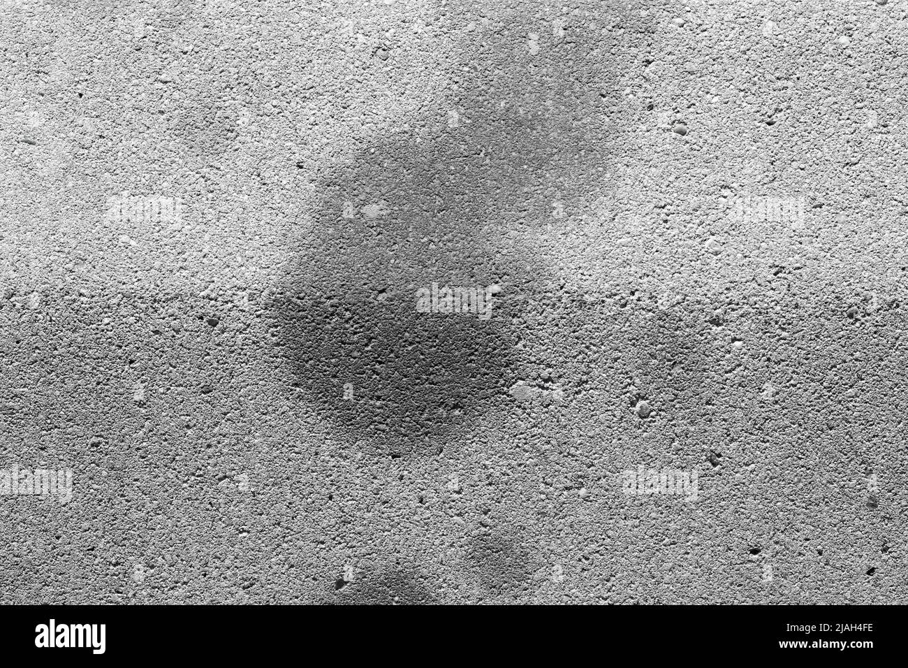 Oil stains on concrete caused by cars. Black engine oil on concrete