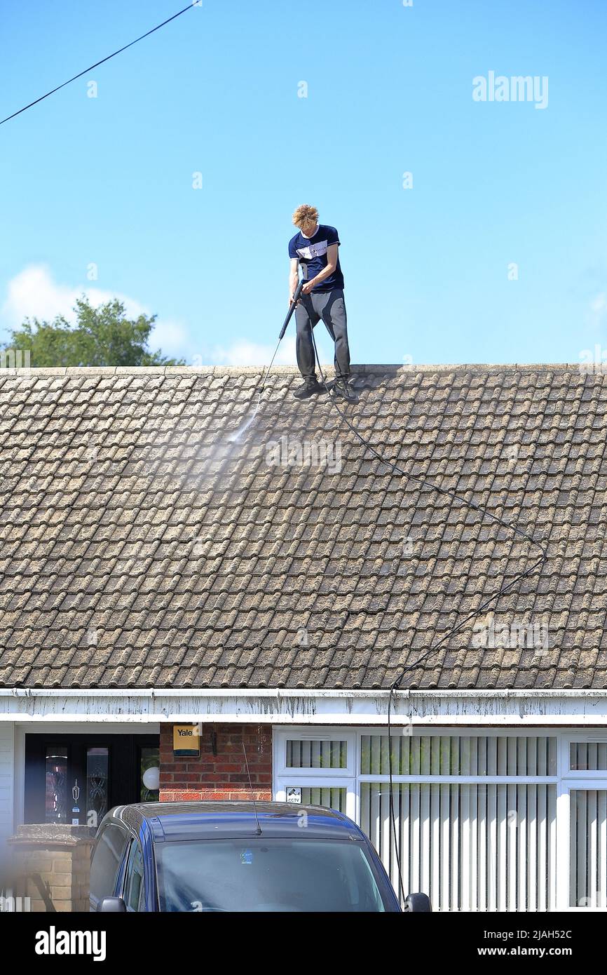 Person working at height jet washing a roof with no safety equipment or PPE  Stock Photo - Alamy