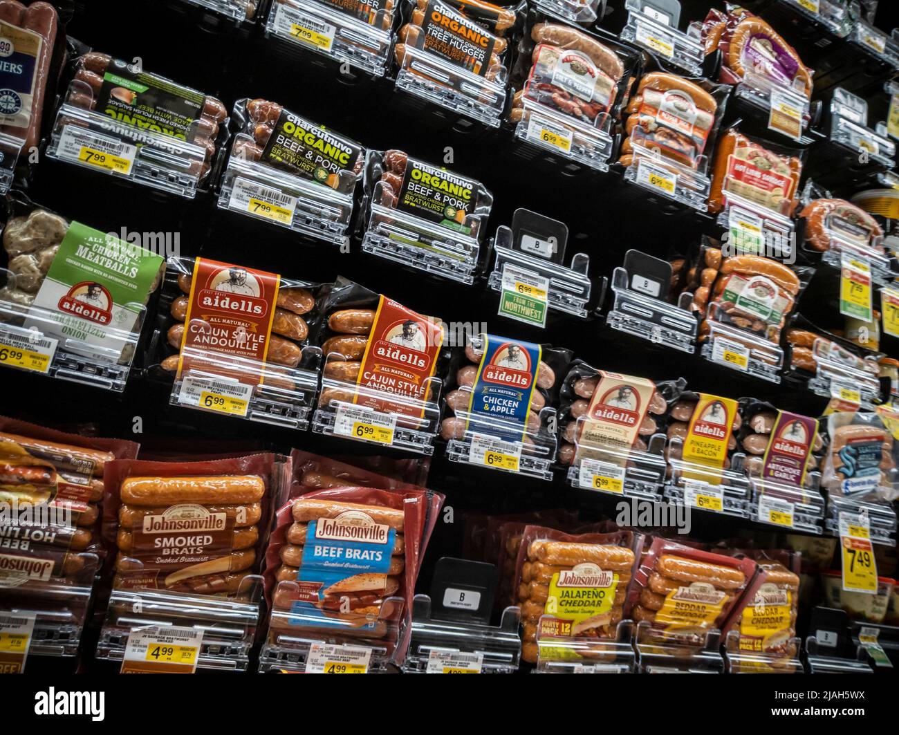 Woodinville, WA USA - circa April 2022: Angled view of a selection of hot dogs, brats, and other varieties of sausages for sale inside a Haggen grocer Stock Photo