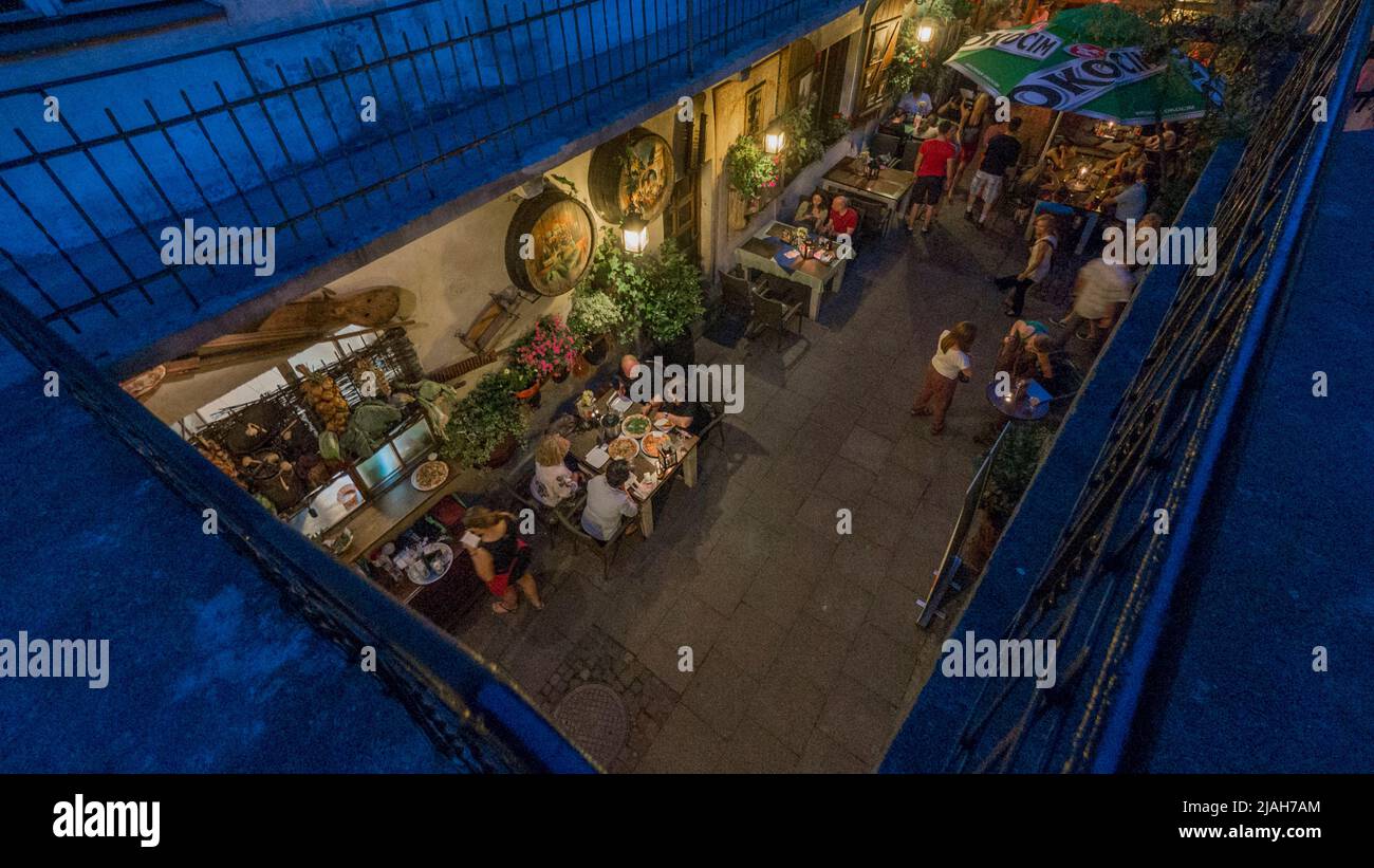 Alleyway between Rabbi Ber Meisels Street and Józefa Street, garden of  the „Stajnia” cafe. Stock Photo