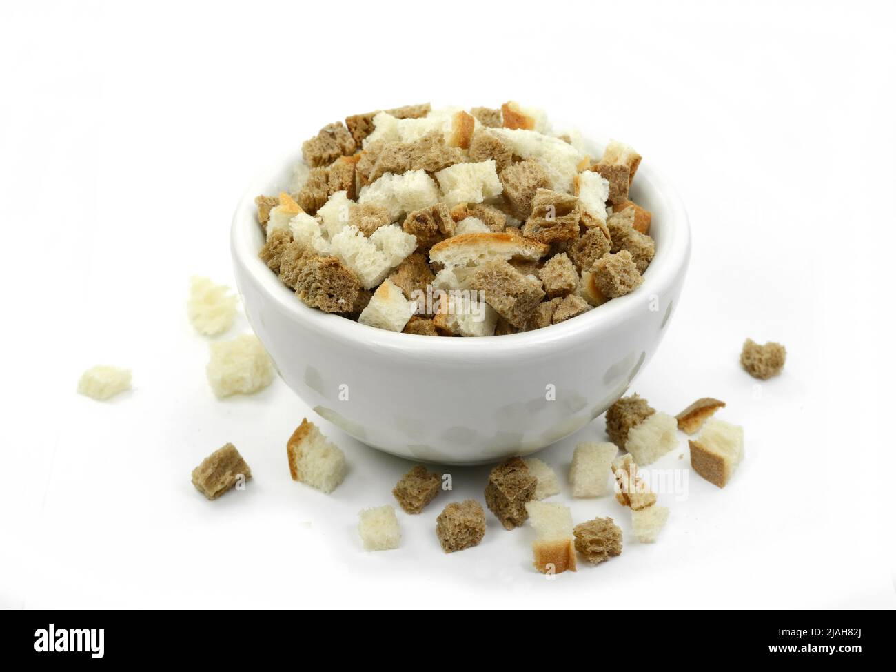 Bread croutons on a white background. Scattered pile of homemade rye
