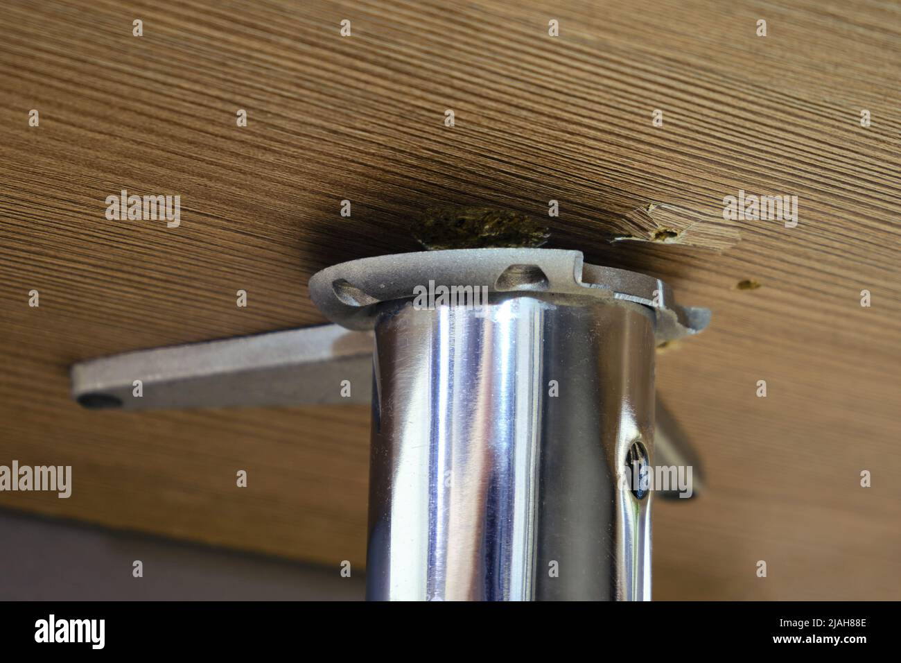 Broken leg of an office desk, repair of furniture made of wood and