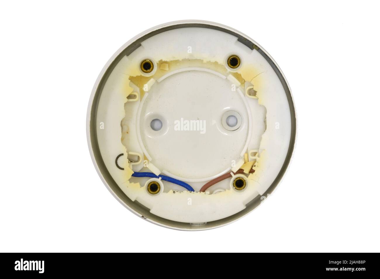 Burnt ceiling light bulb holder with broken plastic, isolated on a