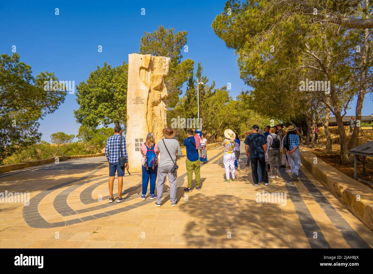 Tourists looking at Carved stone at the entrance to Moses memorial church Mount Nebo Stock Photo