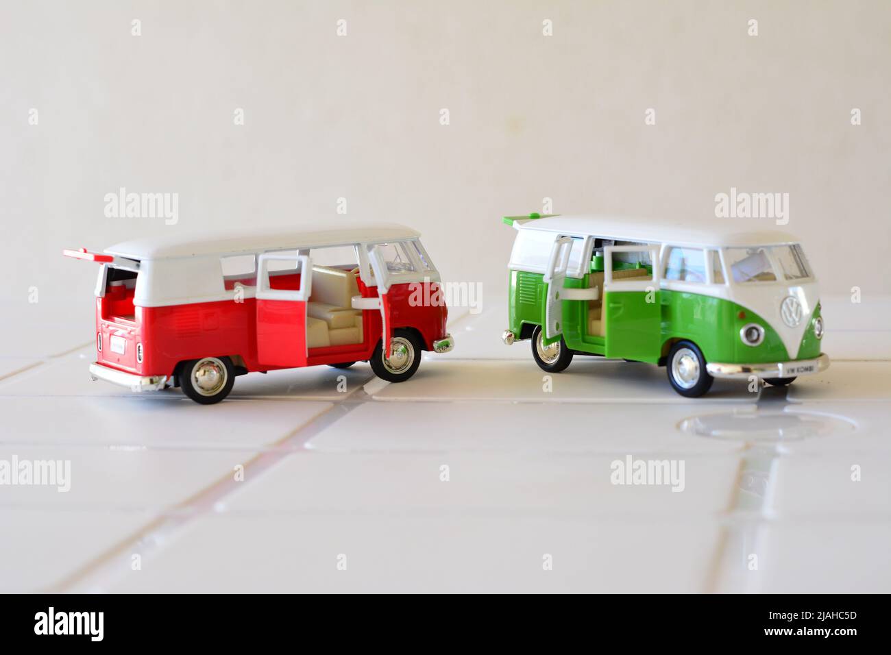 Diecast, Iron miniature, red and green color van, Brazil, South America, side view, selective focus, white background, with open doors, copy space Stock Photo