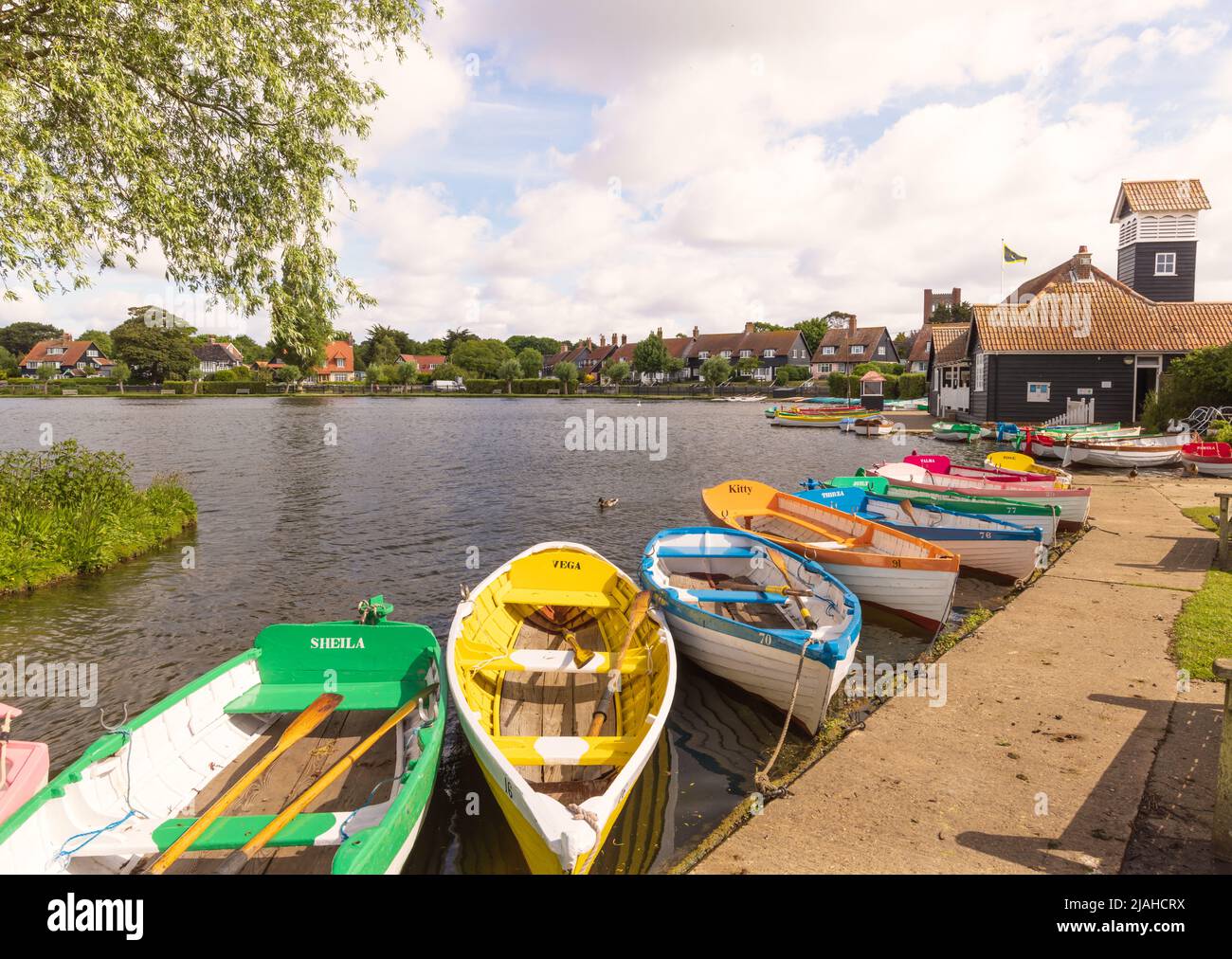 Colourful rowing boats for hire at the Meare. Thorpeness, Suffolk. UK Stock Photo
