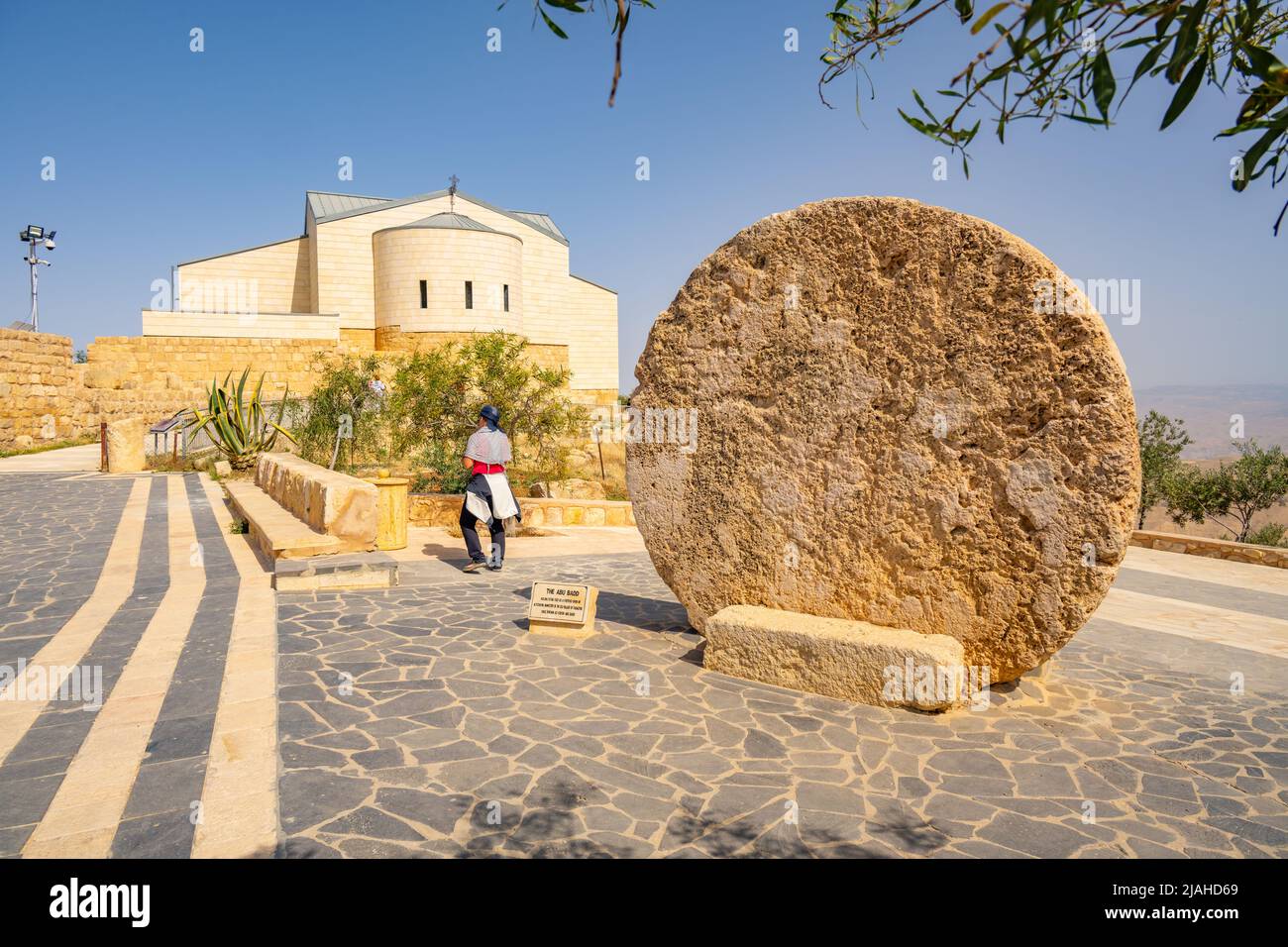 Moses memorial church on the summit of Mount Nebo with stone circular door from nearby tomb Stock Photo