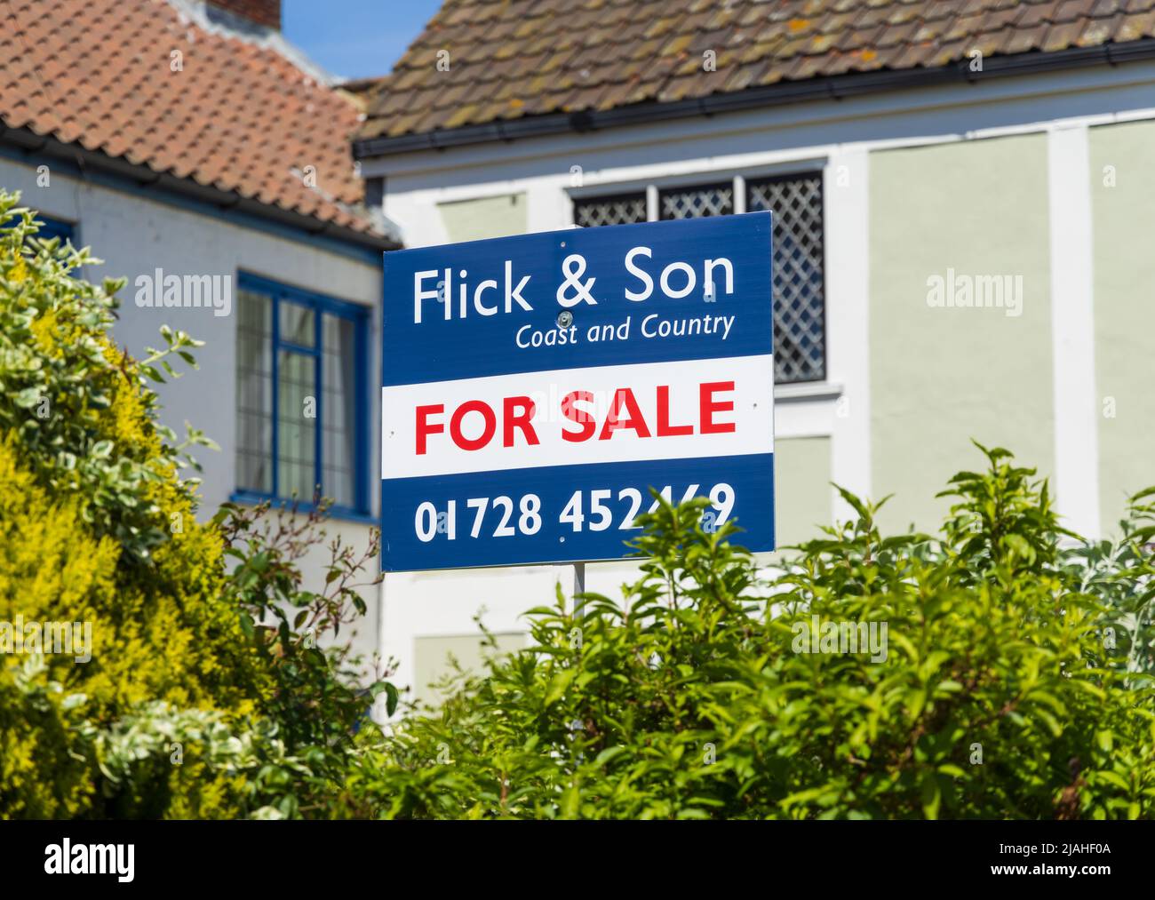 House for sale banner outside a house in Aldeburgh High Street, Suffolk. UK Stock Photo