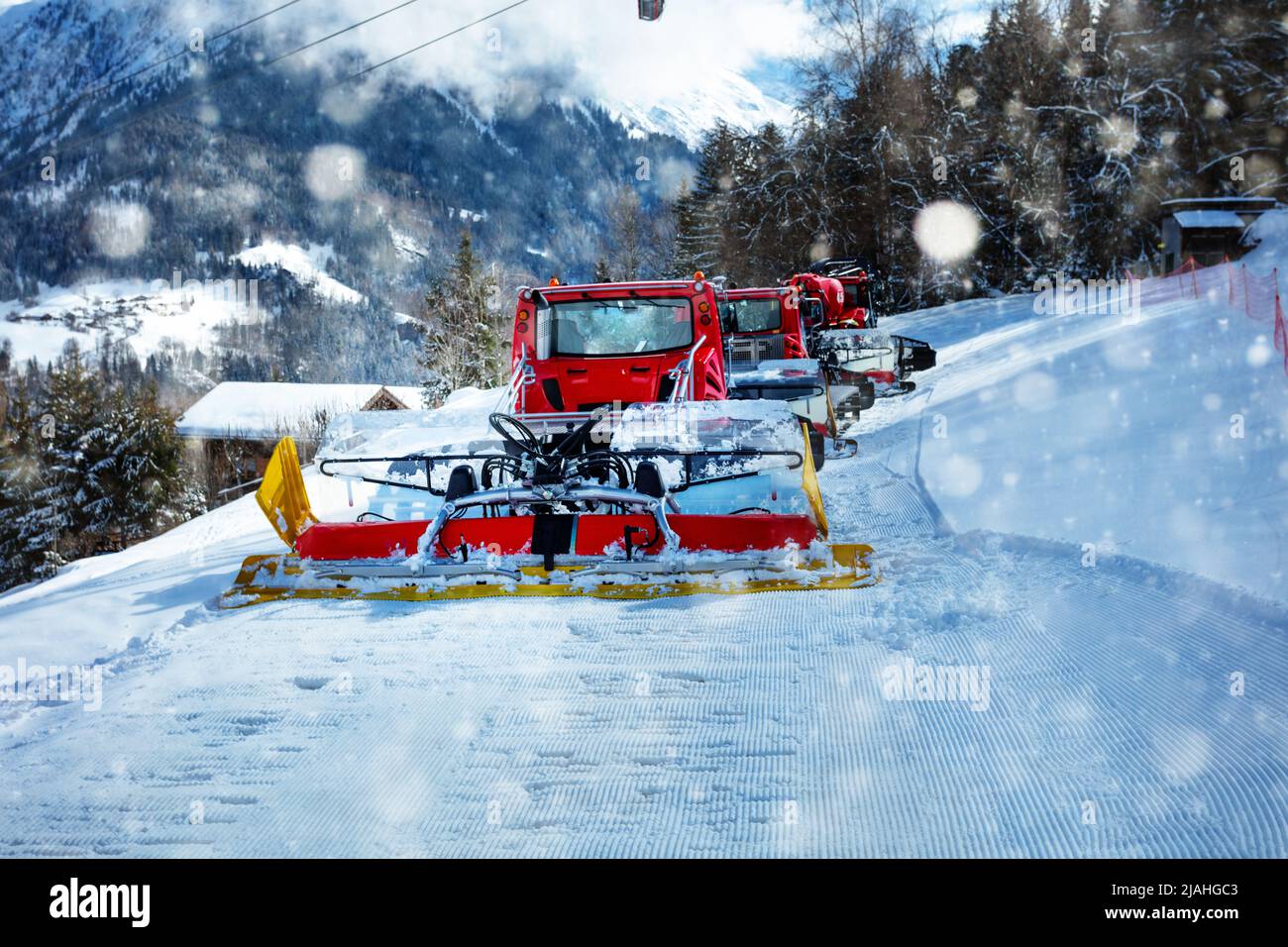 Snowcat ratrack machine make snow at ski resort during snowfall Stock Photo