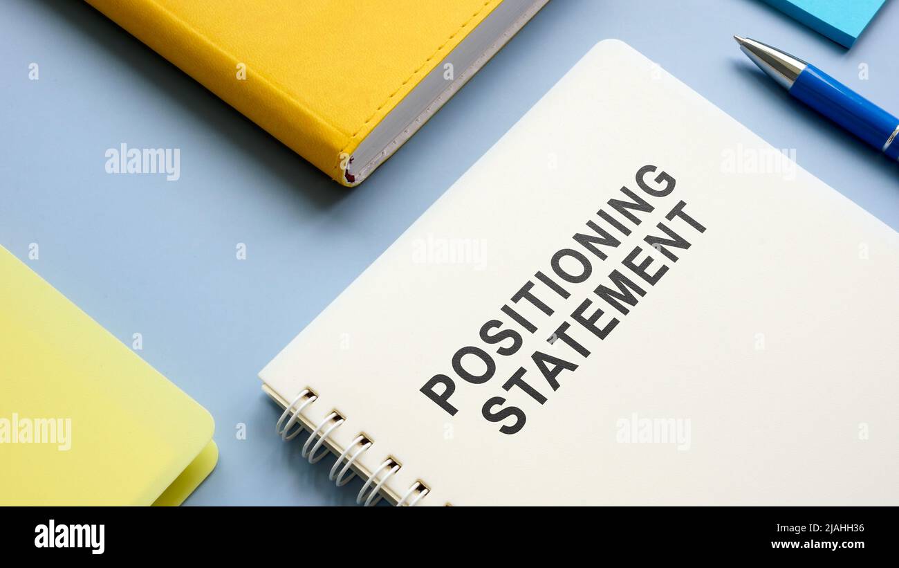 Positioning statement and notepads on the table. Stock Photo
