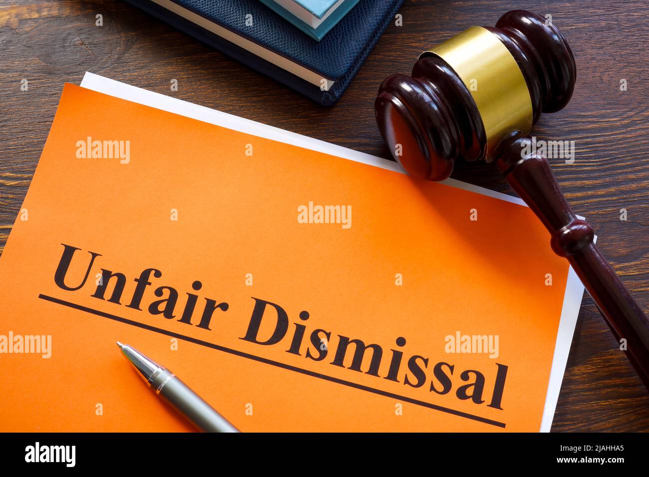 Report about unfair dismissal with book on the table. Stock Photo