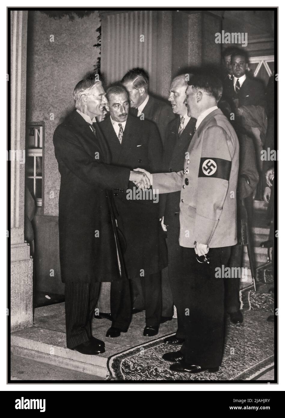 HITLER CHAMBERLAIN 1938 Pre-War Propaganda image of Neville Chamberlain British Prime Minister shaking hands and  meeting Nazi Adolf Hitler in Berlin Germany 30th September 1938 Stock Photo