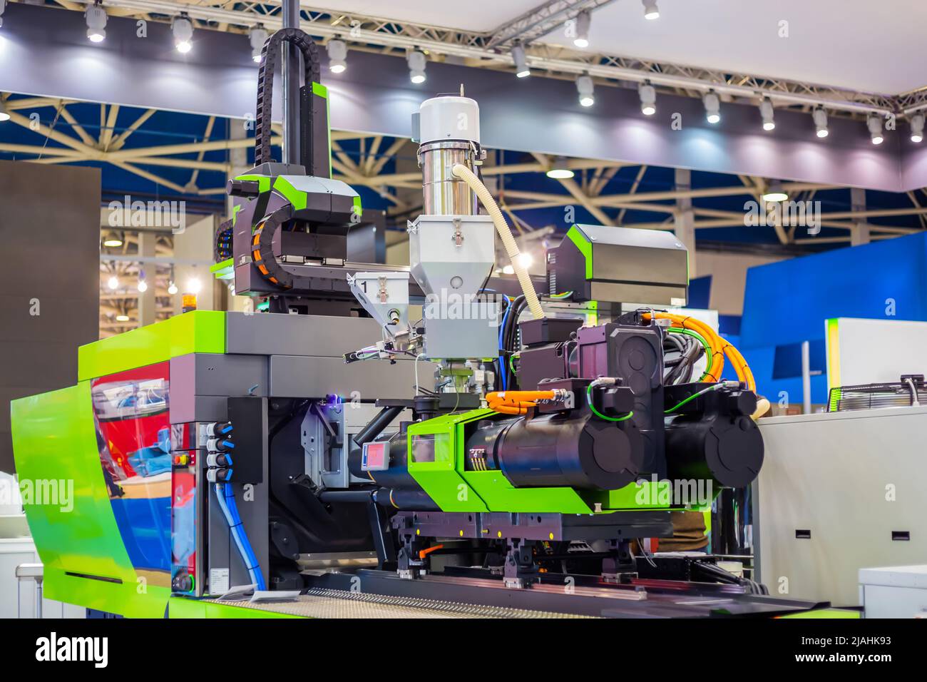 Automatic plastic injection molding machine during work at exhibition