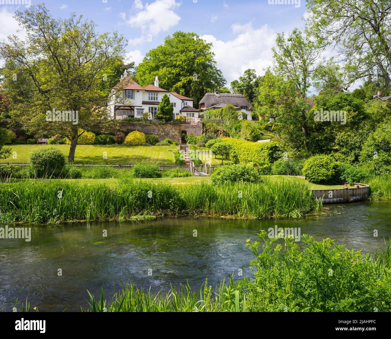 Riverside houses and gardens on the bank of the River Itchen at Shawford, Hampshire, England. Stock Photo