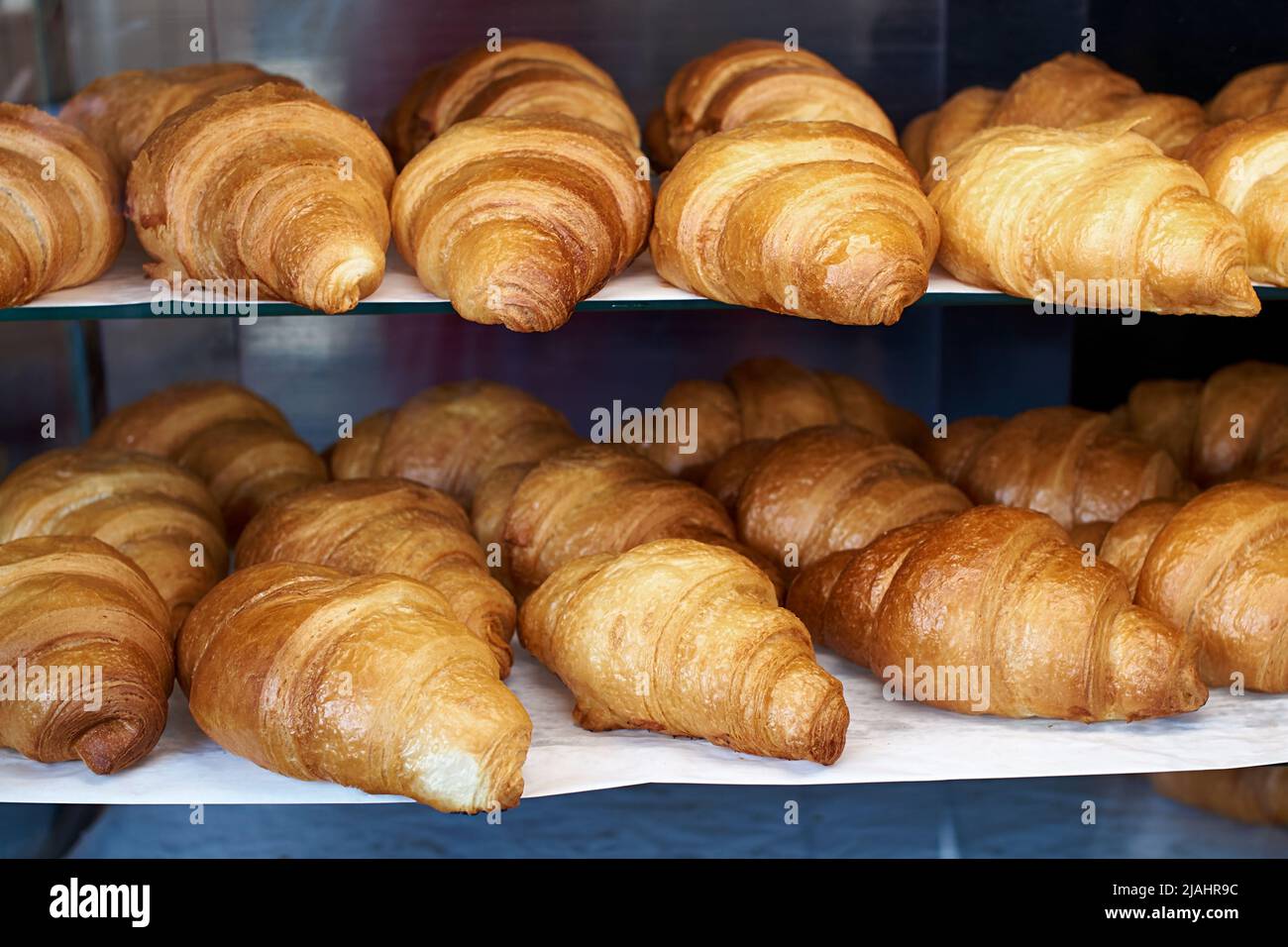 Lots of fresh french croissants on the store shelf Stock Photo