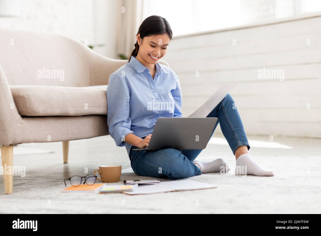 Happy asian woman working from home, using computer Stock Photo - Alamy