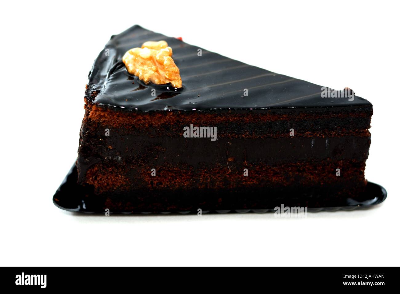 Fudge chocolate cake tart triangular piece made of fudge cake, walnut ...