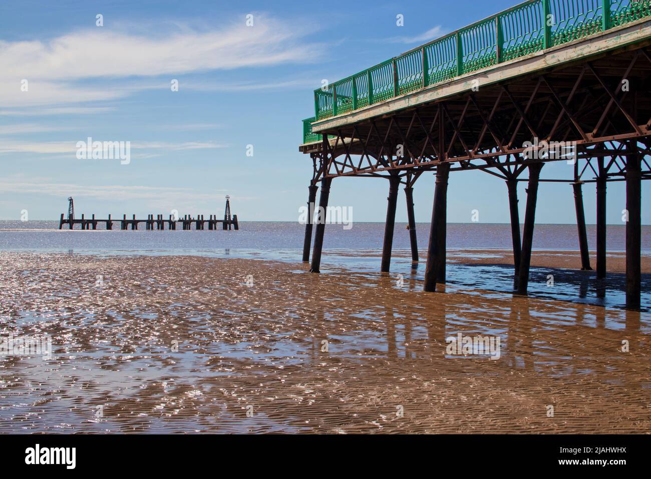 Viewing the old pier in St Annes on Sea from the beach close to the end of the newer pier Stock Photo