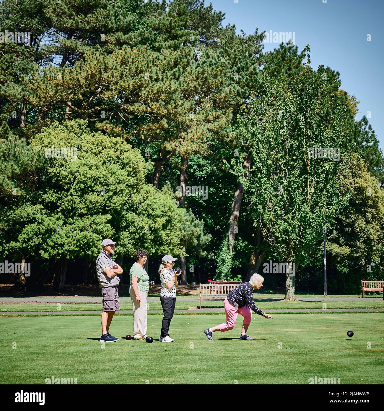 Group of senior people playing Crown green bowling in Lowther Gardens,Lytham,UK Stock Photo