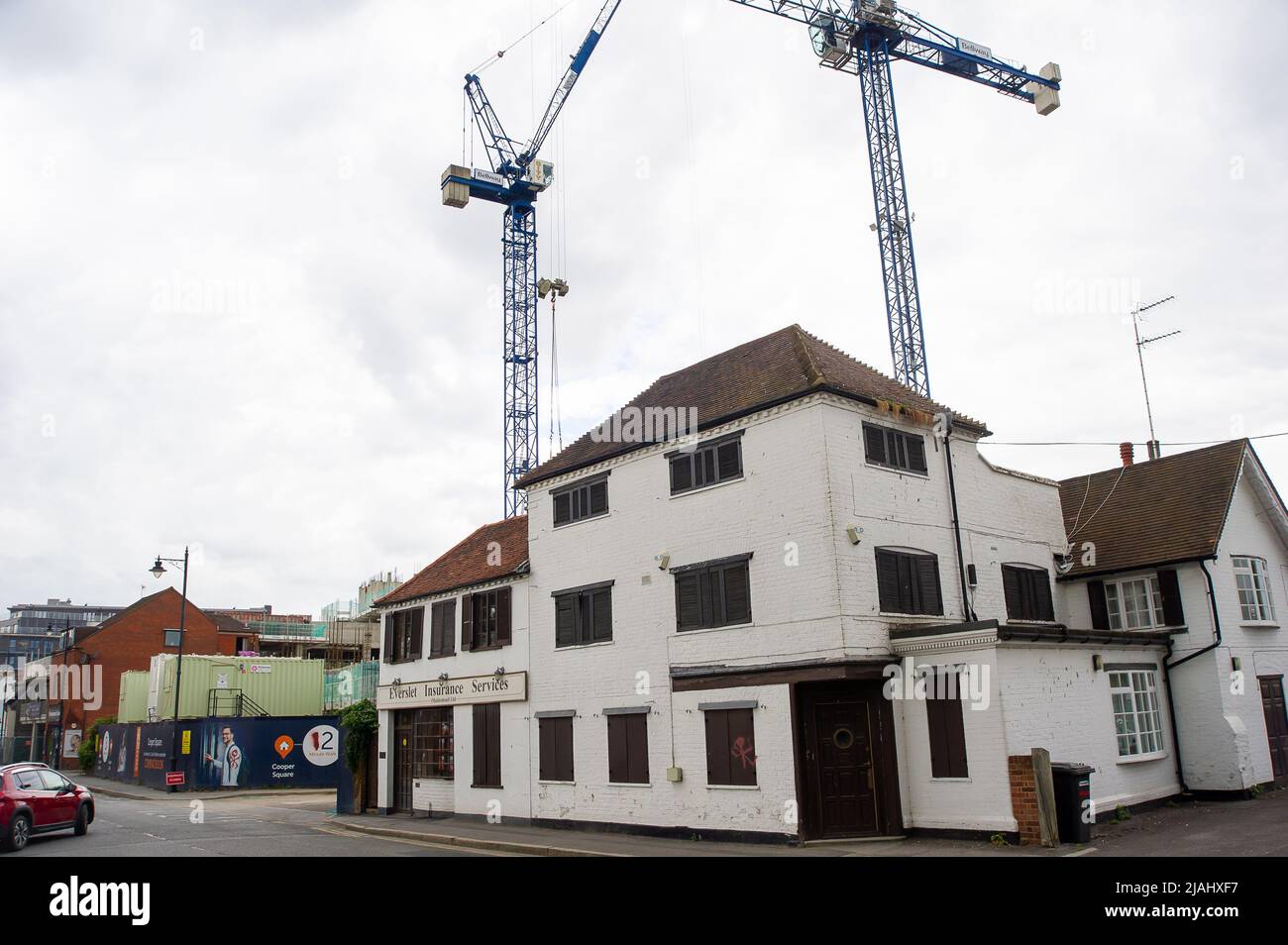 Maidenhead, Berkshire, UK. 30th May, 2022. Another building is boarded up as hundreds of new apartments are being built in Maidenhead Town Centre as part of a huge regeneration project. Maidenhead is now on the Elizabeth Line and property prices are increasing as a result. Credit: Maureen McLean/Alamy Stock Photo
