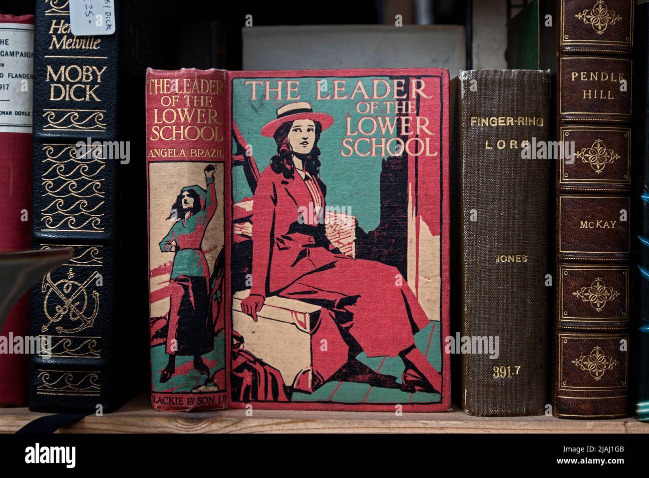 Vintage copy of 'The Leader of the Lower School' by Angela Brazil in the window of a secondhand bookseller in Edinburgh, Scotland, UK. Stock Photo