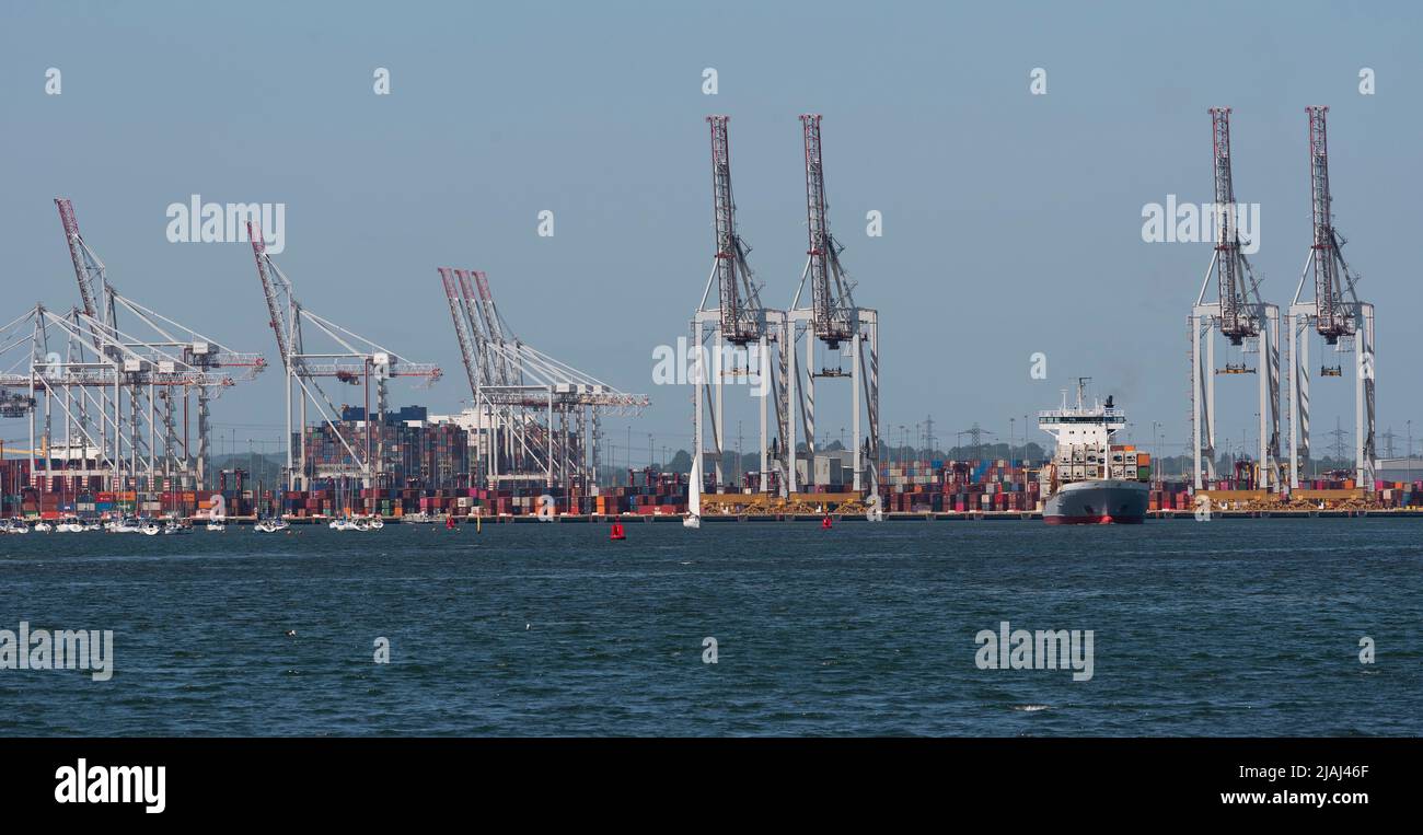 Southampton, England, UK. 2022. View of cranes and shipping at DP World container terminal and a small container ship the BF Fortaleza departing. Sout Stock Photo