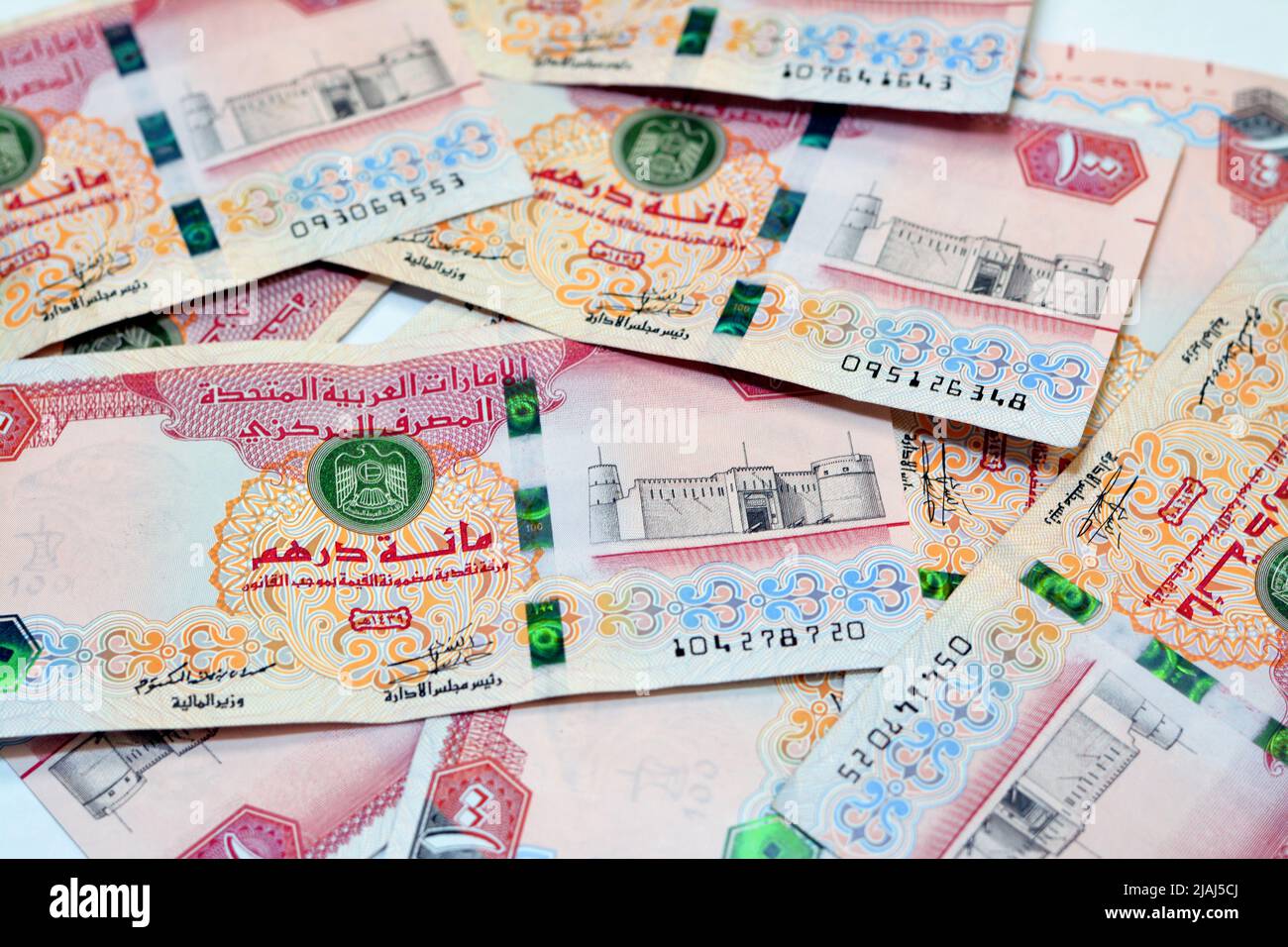 a pile of 100 AED one hundred Dirhams banknote currency of United Arab Emirates UAE with a picture of Al Fahidi Fort, A stack of Emirates money Stock Photo