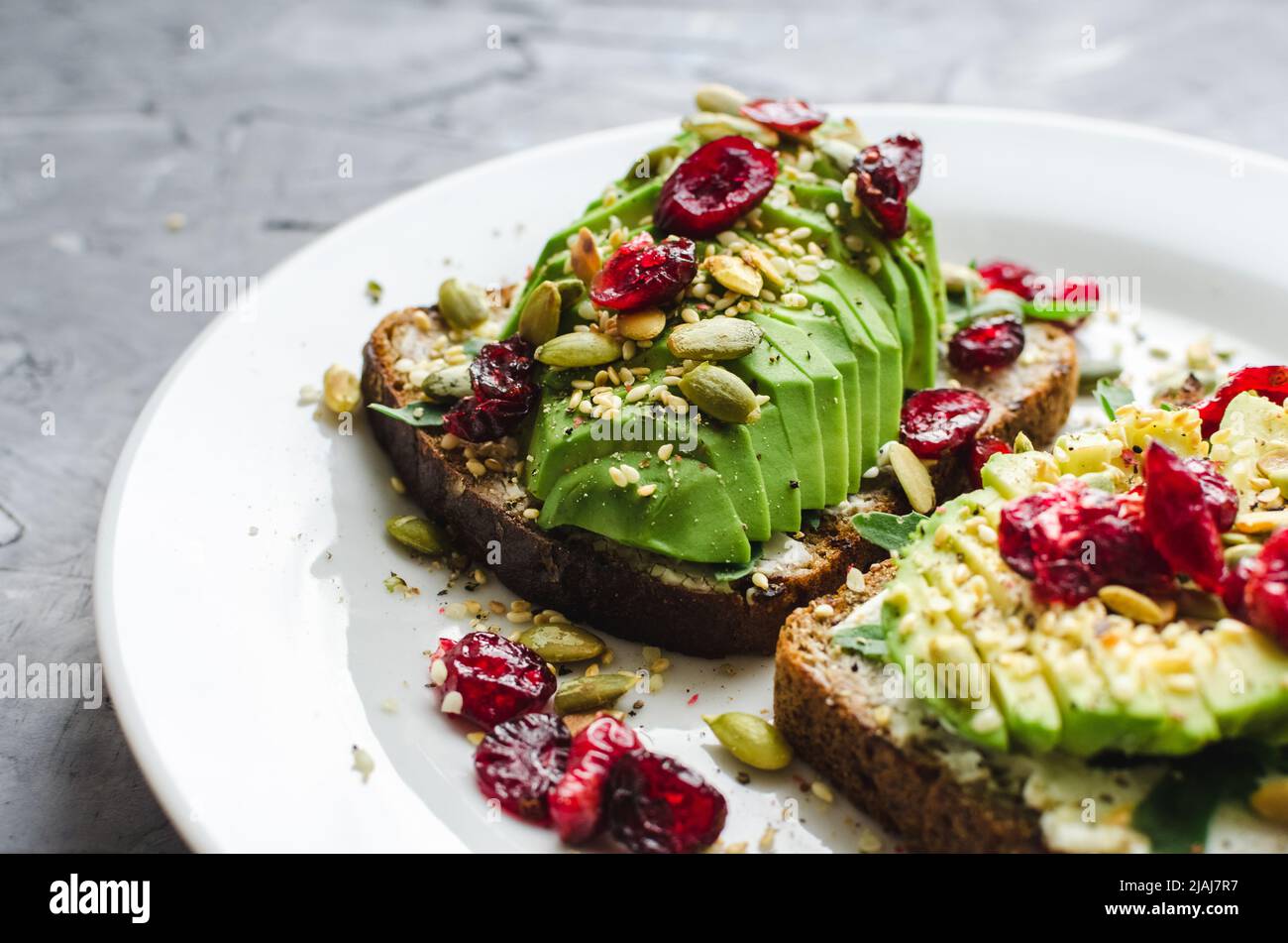 Healthy avocado toasts for breakfast or lunch with rye bread, cream