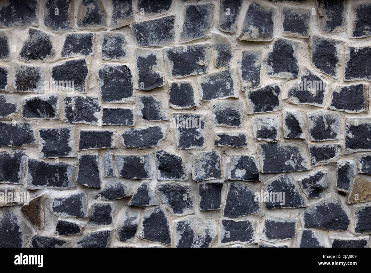 Paving stone walkway abstract background. Rock texture. Dark grey brick wall. Abstract gray grunge texture. Grey granite surface, floor. Stock Photo