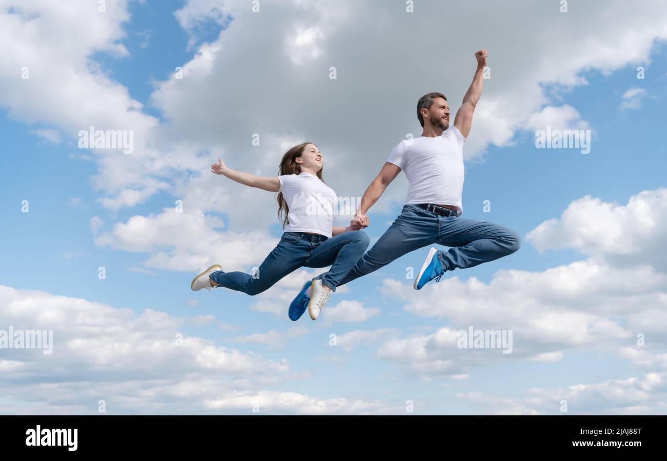 happy father and daughter jump in sky. family day Stock Photo - Alamy